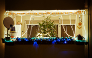 Symbolbild: grell erleuchteter, weihnachtlich geschmückter Balkon